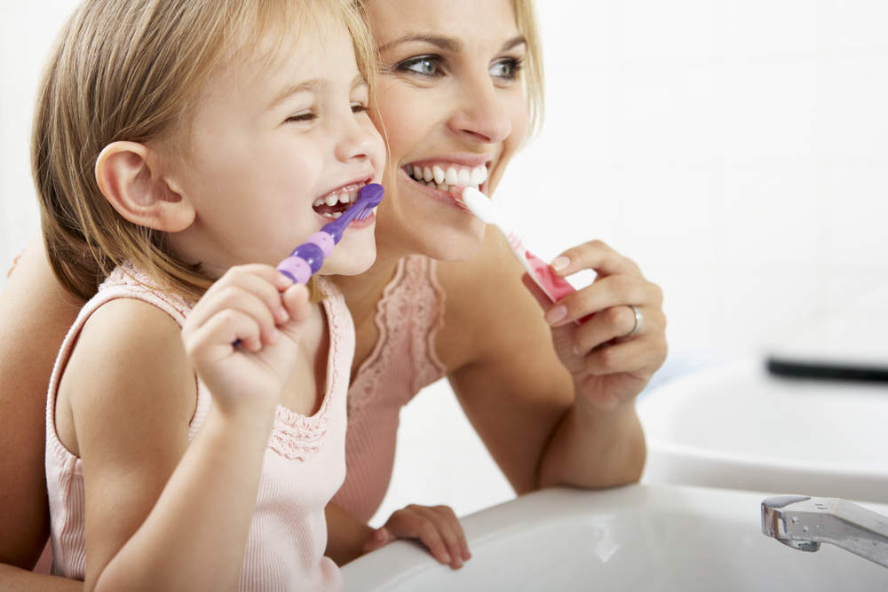 mom-and-daughter-brush-teeth-together